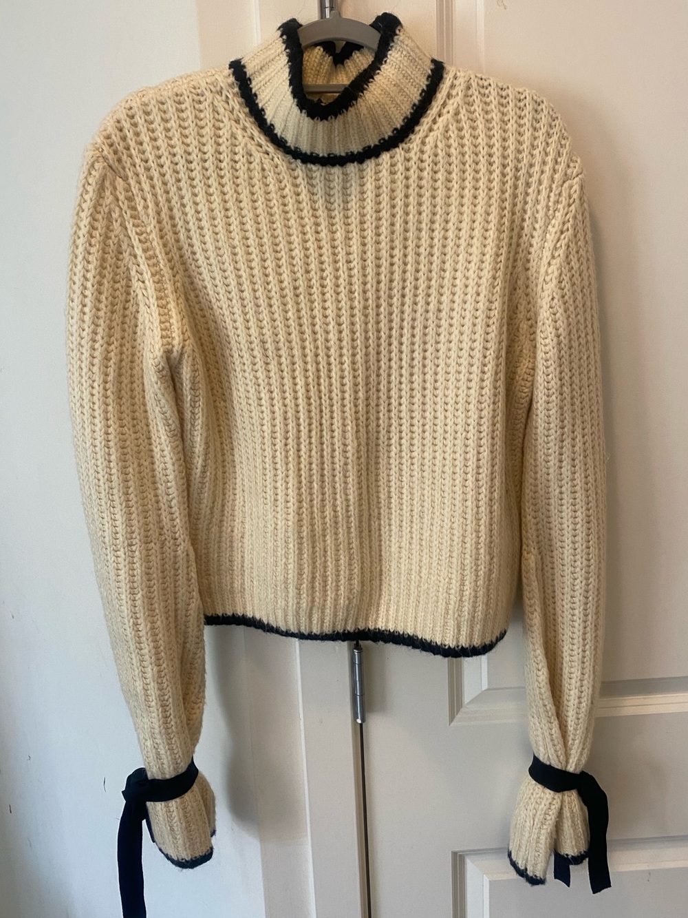 JW ANDERSON Cream Ribbed Turtleneck Sweater with Black Trim and Bow Cuffs